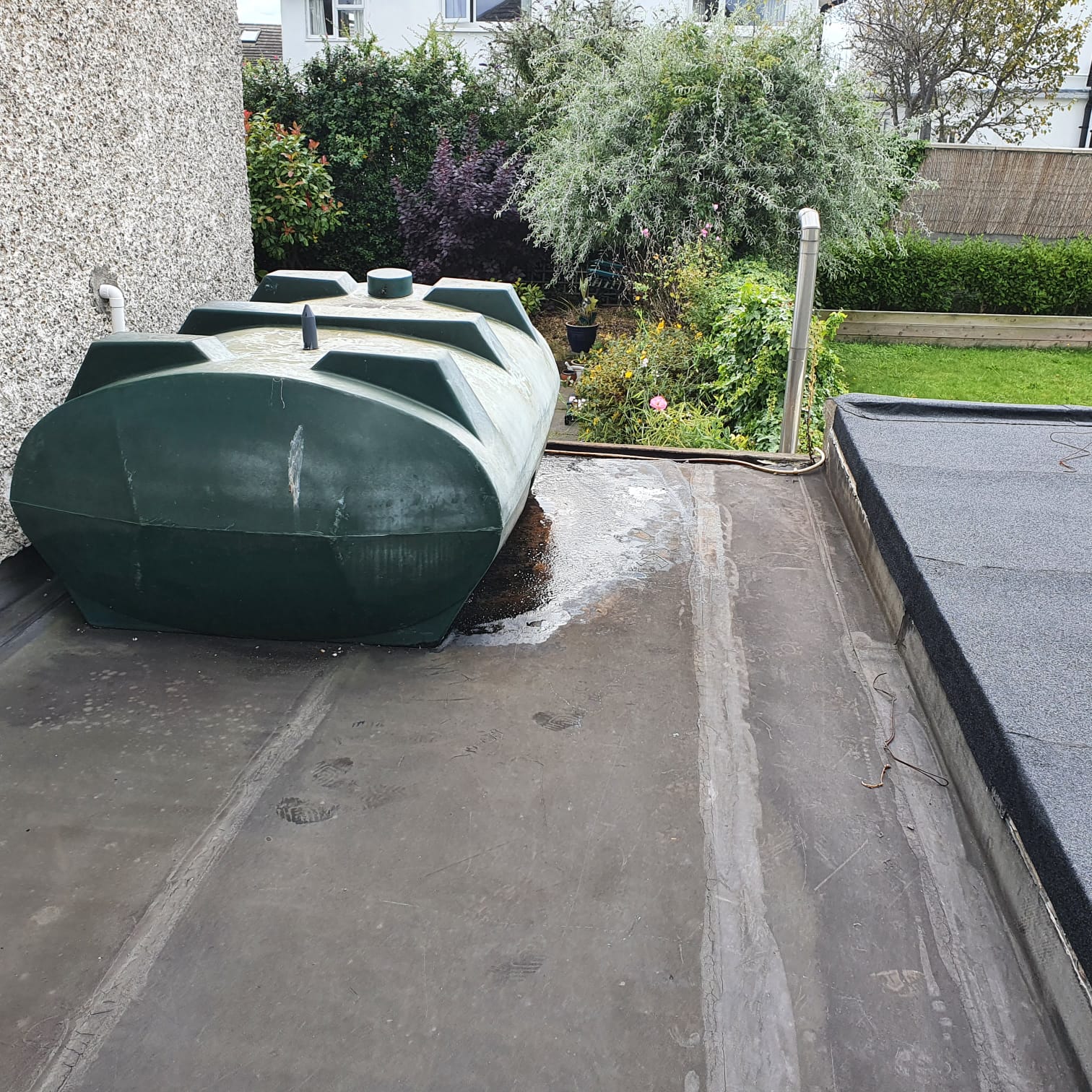 Leak beneath a tank on a flat roof